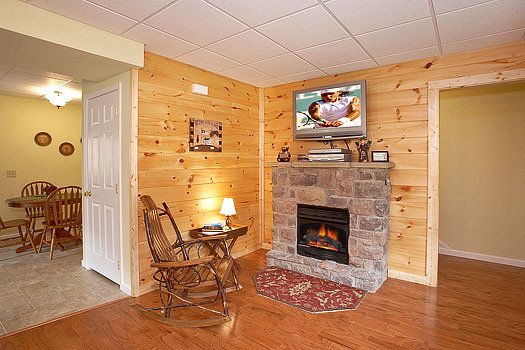 Stone fireplace in the living room at Heaven Sent, a 2-bedroom cabin rental located in Pigeon Forge