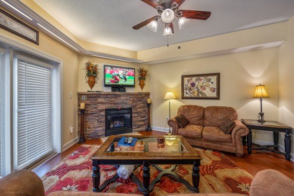 Fireplace and TV in the living room at Heart of Gatlinburg, a 2 bedroom cabin rental located in Gatlinburg