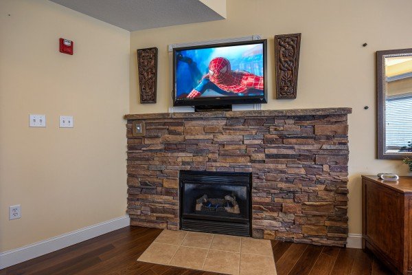 Fireplace and tv in the master bedroom at Heart of Gatlinburg, a 2 bedroom cabin rental located in Gatlinburg