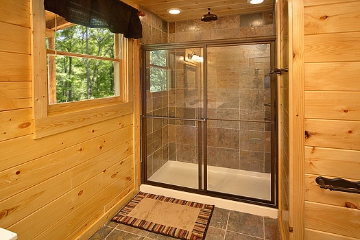 Main level bath with shower at Pool House, a 2 bedroom cabin rental located in Gatlinburg