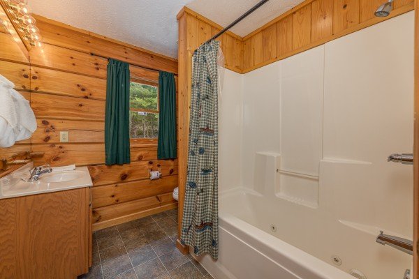 Bathroom with a tub and shower at Wildlife Retreat, a 3 bedroom cabin rental located in Pigeon Forge