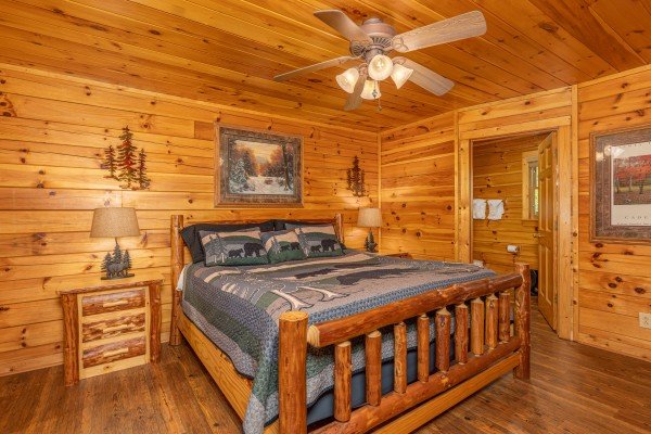 Bedroom with a log bed, night stands, and lamps at Moonlit Pines, a 2 bedroom cabin rental located in Pigeon Forge
