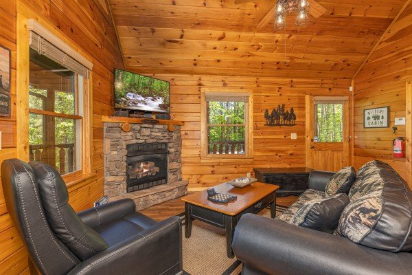 Fireplace and TV in a living room at Moonlit Pines, a 2 bedroom cabin rental located in Pigeon Forge