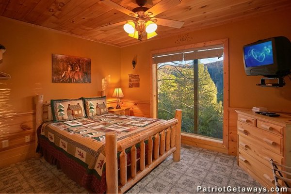 Bedroom with log bed, dresser, and TV at A Getaway with a View, a 2 bedroom cabin rental located in Pigeon Forge