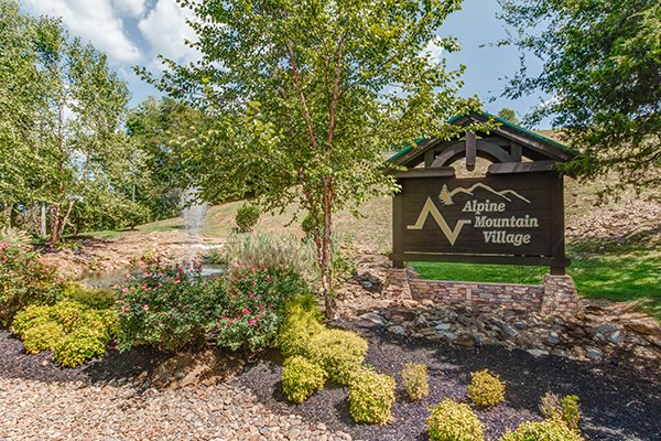 alpine mountain village sign at resort setting at alpine tranquility a 4 bedroom cabin rental located in pigeon forge