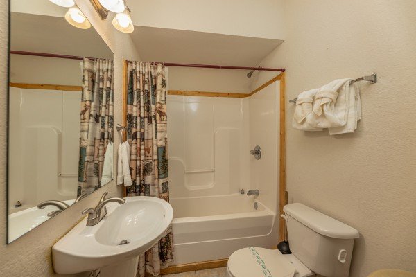 Bathroom with a tub and shower at Alpine Tranquility, a 4 bedroom cabin rental located in Pigeon Forge