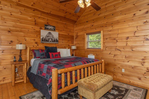 Bedroom with a log bed, two night stands, lamps, and bench at 1 Awesome View, a 3 bedroom cabin rental located in Pigeon Forge