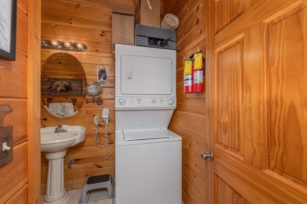 Stacked washer and dryer in a half bath at 1 Awesome View, a 3 bedroom cabin rental located in Pigeon Forge