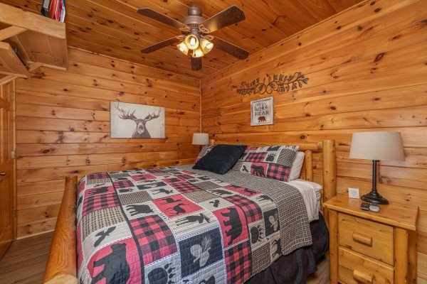 Bedroom with a bed, two night stands, and lamps at 1 Awesome View, a 3 bedroom cabin rental located in Pigeon Forge