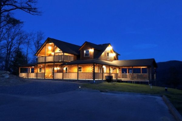 The cabin lit up against the night sky at Gonzo's Outpost, a 3-bedroom cabin rental located in Pigeon Forge