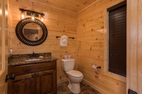 Main floor half bath at Gonzo's Outpost, a 3-bedroom cabin rental located in Pigeon Forge