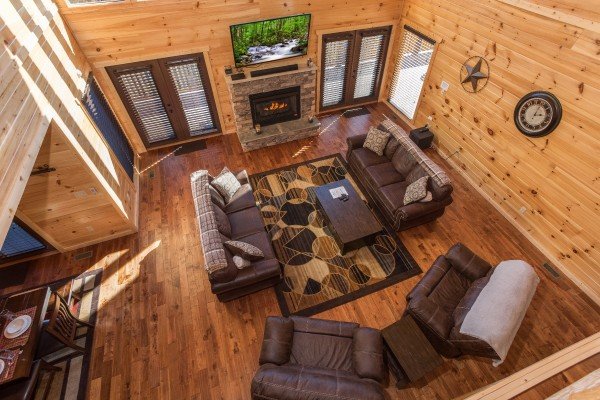 Looking down at the living room from the lofted game room at Gonzo's Outpost, a 3-bedroom cabin rental located in Pigeon Forge