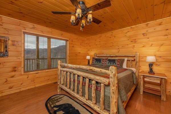 Bedroom with a king bed, night stands, and lamps at J's Hideaway, a 4 bedroom cabin rental located in Pigeon Forge