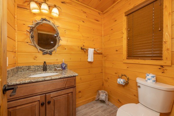Half bath at J's Hideaway, a 4 bedroom cabin rental located in Pigeon Forge