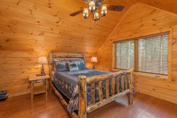 Log bed, two night stands, and two lamps at J's Hideaway, a 4 bedroom cabin rental located in Pigeon Forge