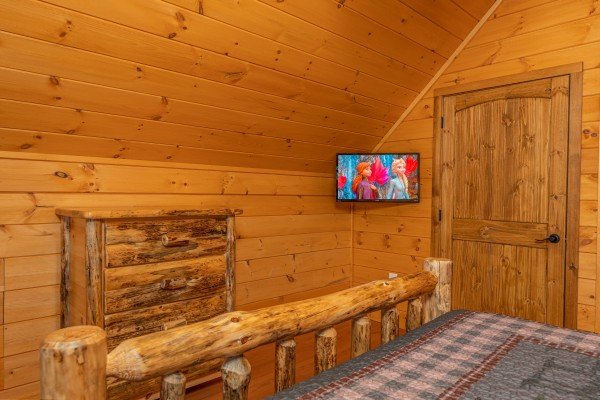 Dresser and TV in a bedroom at J's Hideaway, a 4 bedroom cabin rental located in Pigeon Forge