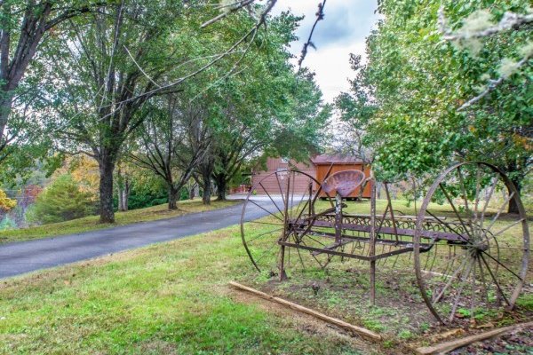 Old farm equipment at Leconte Nirvana, a 3 bedroom cabin rental located in Pigeon Forge