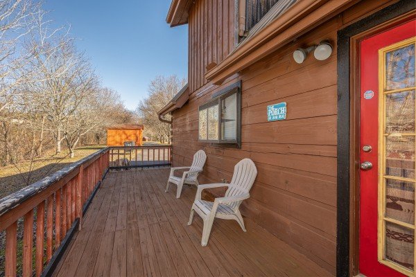 Adirondack chairs on a deck at Leconte Nirvana, a 3 bedroom cabin rental located in Pigeon Forge