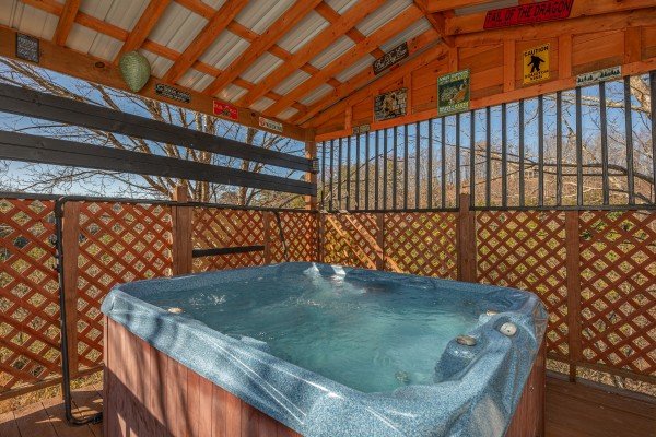 Hot tub under a covered deck at Leconte Nirvana, a 3 bedroom cabin rental located in Pigeon Forge