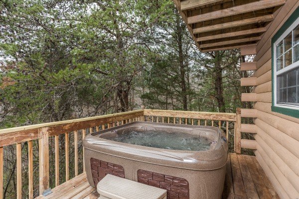 Hot tub on the deck with woods views at Bear it All, a 2-bedroom cabin rental located in Sevierville