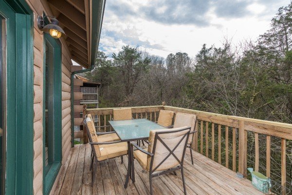 Outdoor dining for six on the deck at Bear it All, a 2-bedroom cabin rental located in Sevierville