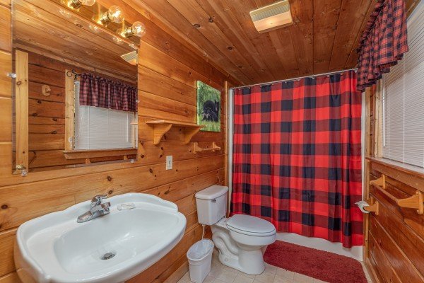 Bathroom with a tub and shower at Smoky Mountain High, a 1 bedroom cabin rental located in Pigeon Forge