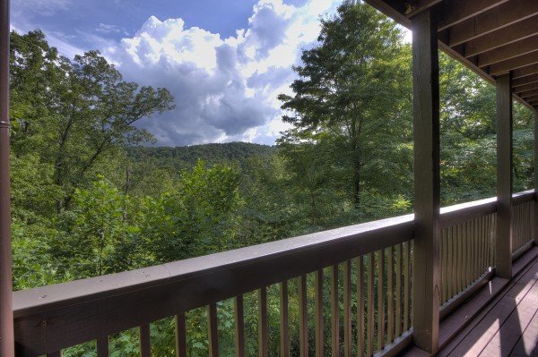 Covered deck and mountain views at Wonders in the Sky, a 3 bedroom cabin rental located in Gatlinburg