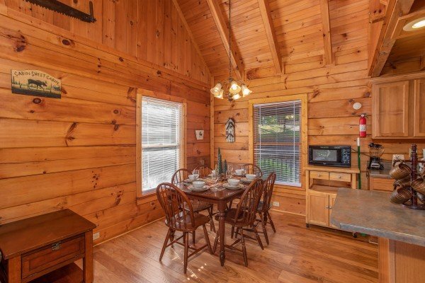 Dining table for six at Wonders in the Sky, a 3 bedroom cabin rental located in Gatlinburg