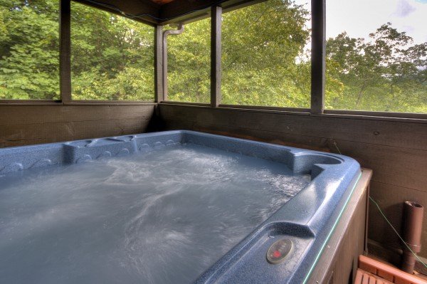 Hot tub on a covered deck at Wonders in the Sky, a 3 bedroom cabin rental located in Gatlinburg