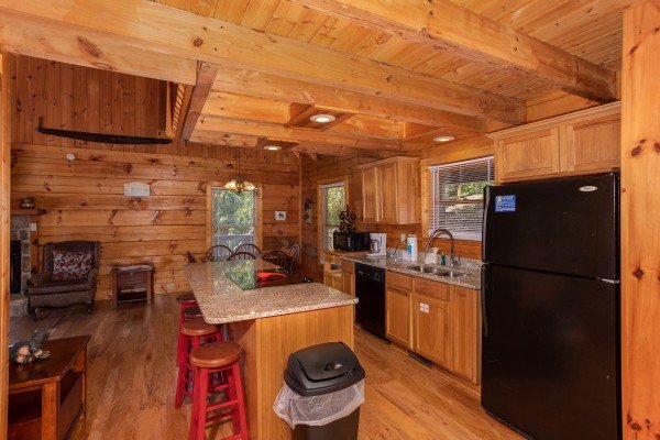 Kitchen with black appliances and dining space at Wonders in the Sky, a 3 bedroom cabin rental located in Gatlinburg