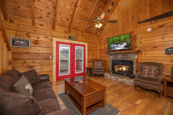 Living room with sofa, fireplace, and TV at Wonders in the Sky, a 3 bedroom cabin rental located in Gatlinburg