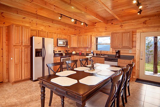 Dining table with six chairs at Looky Yonder, a 2 bedroom cabin rental located in Gatlinburg