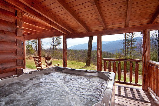Hot tub under covered deck at Looky Yonder, a 2 bedroom cabin rental located in Gatlinburg