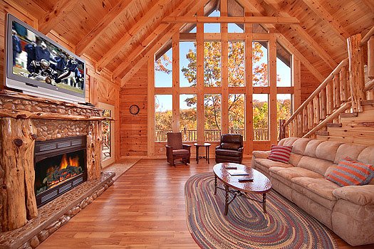 Living room with stone fireplace at Looky Yonder, a 2 bedroom cabin rental located in Gatlinburg