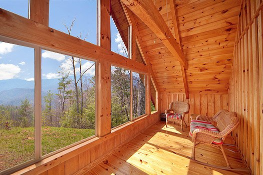 Sun room with Smoky Mountain views from Looky Yonder, a 2 bedroom cabin rental located in Gatlinburg