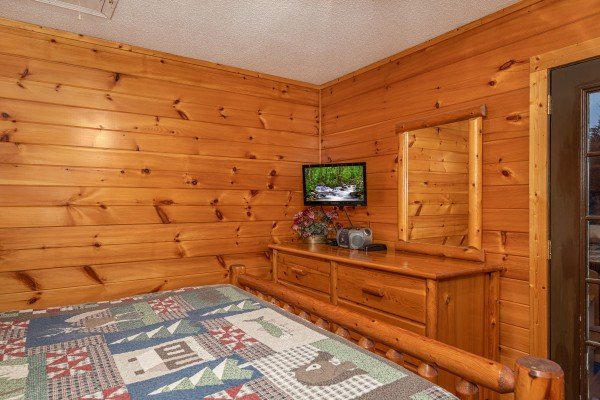 TV and dresser in a bedroom at Pine Splendor, a 5 bedroom cabin rental located in Pigeon Forge