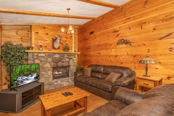 Second living room with fireplace & tv at Pine Splendor, a 5 bedroom cabin rental located in Pigeon Forge