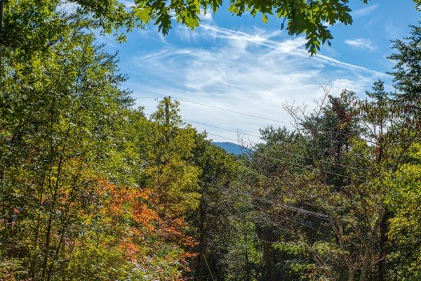 Mountain peak above the trees at Pine Splendor, a 5 bedroom cabin rental located in Pigeon Forge