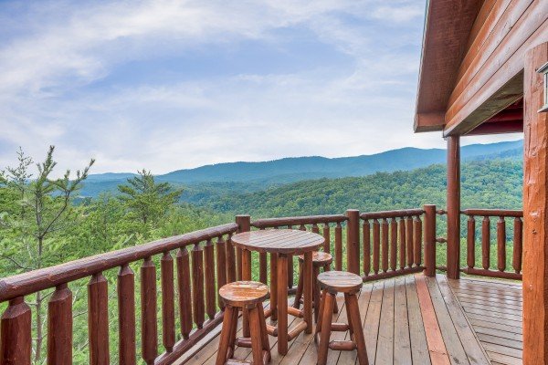 Dining table for three with mountain views at Horse'n Around, a 3 bedroom cabin rental located in Pigeon Forge