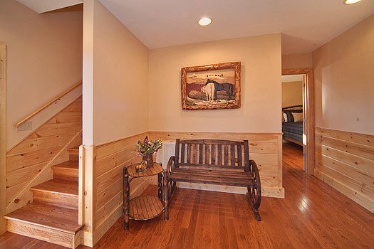 Bench seating at the first floor stair landing at Horse'n Around, a 3 bedroom cabin rental located in Pigeon Forge