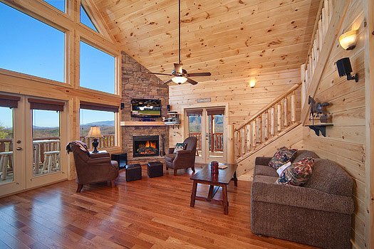 Living room with stone fireplace at Horse'n Around, a 3 bedroom cabin rental located in Pigeon Forge