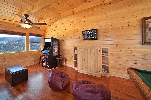 Lofted game room with bean bag chairs and arcade cabinet at Horse'n Around, a 3 bedroom cabin rental located in Pigeon Forge