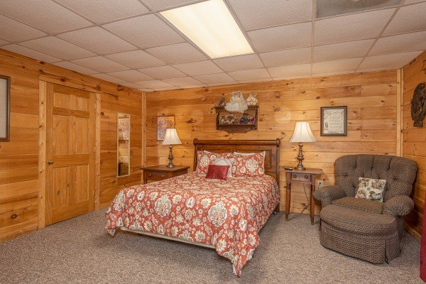 Bedroom with two night tables, lamps, and chair at Fox Ridge, a 3 bedroom cabin rental located in Pigeon Forge