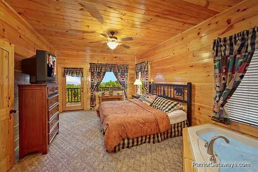First floor bedroom with king sized bed at Majestic Mountain View, a 2 bedroom cabin rental located in Pigeon Forge