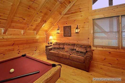 Sofa bed in the lofted game room at Majestic Mountain View, a 2 bedroom cabin rental located in Pigeon Forge