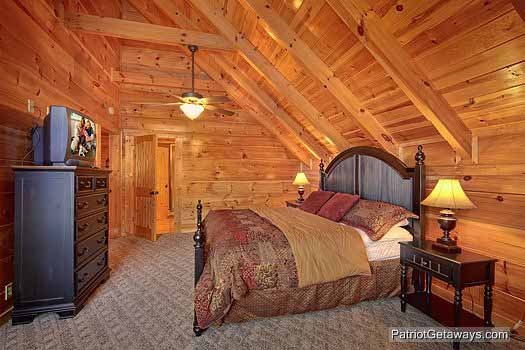 Third floor bedroom with king sized bed and TV on top of chest of drawers at Majestic Mountain View, a 2 bedroom cabin rental located in Pigeon Forge