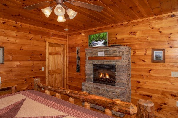 Fireplace and TV in a bedroom at 5 Star View, a 3 bedroom cabin rental located in Gatlinburg
