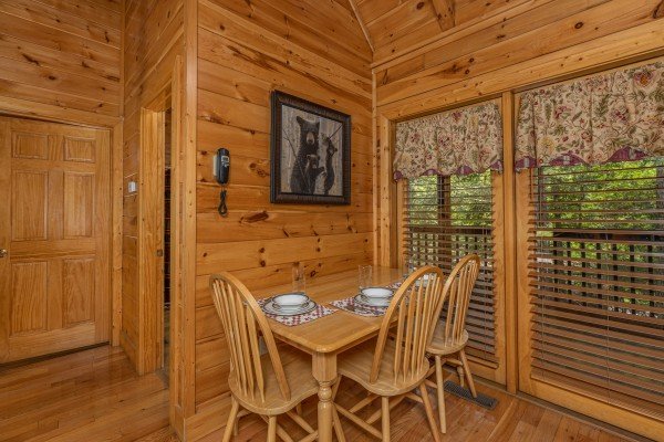 Dining table for three at Location Location Location, a 1 bedroom cabin rental located in Pigeon Forge