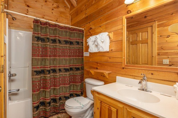Bathroom with a tub and shower at Location Location Location, a 1 bedroom cabin rental located in Pigeon Forge