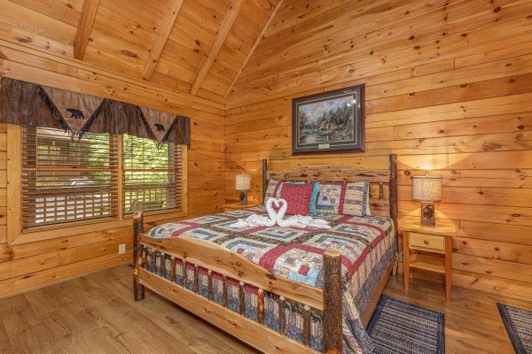 Bedroom with a king bed, night stands, and lamps at Location Location Location, a 1 bedroom cabin rental located in Pigeon Forge